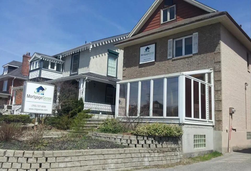 The Mortgage Sense office, a brick house with a glass sunroom and the Mortgage Sense sign out front, at 11 Bradford Street in Barrie